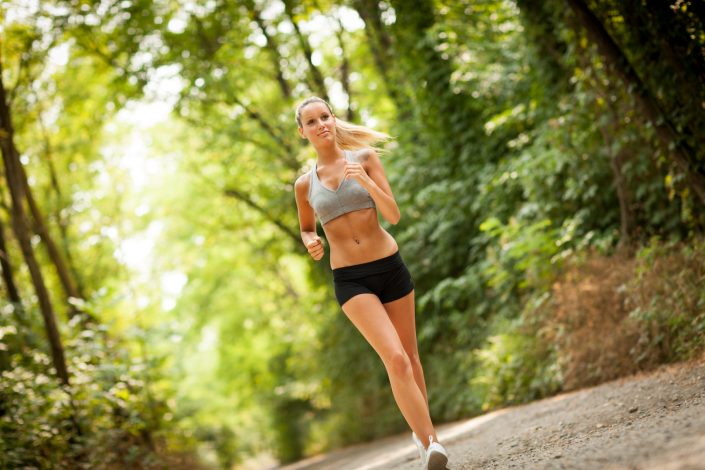 Beautiful blonde woman is doing running workout